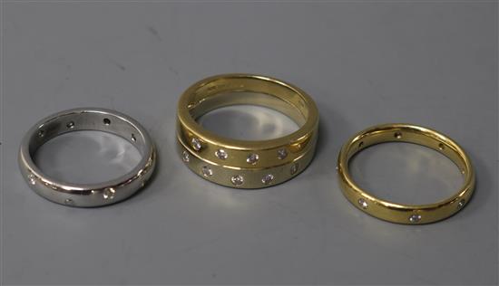 Two modern 18ct gold and gypsy set diamond rings and a white metal and diamond gypsy set diamond ring. gross 13.7 grams.